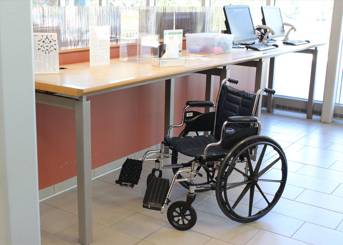 Accessibility photo with wheelchair and accessible desk