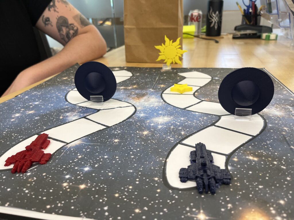 a space themed board game with jet pieces and UFO crafts built using the 3D printer.